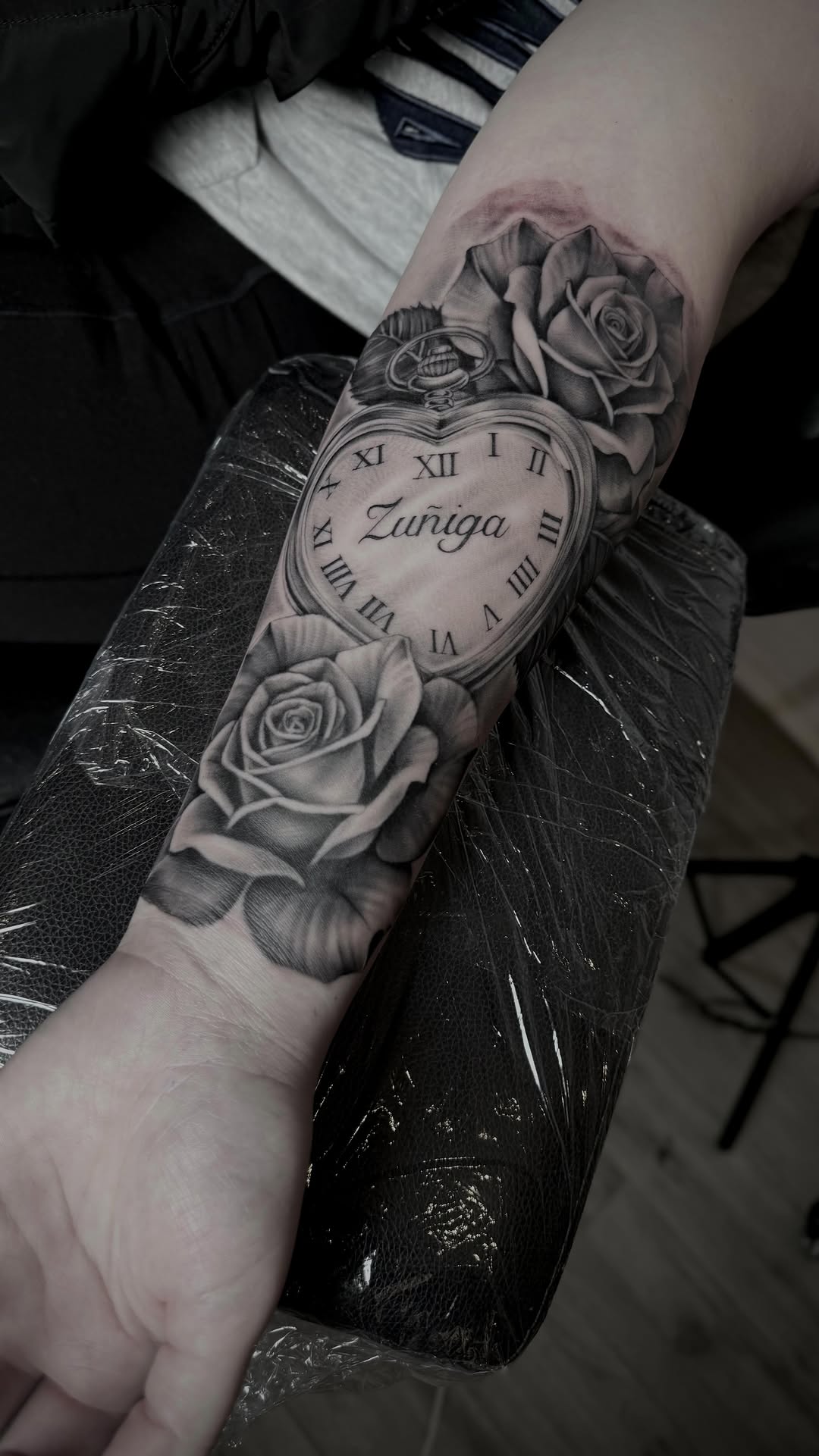 Photorealistic black-and-gray pocket watch with roses