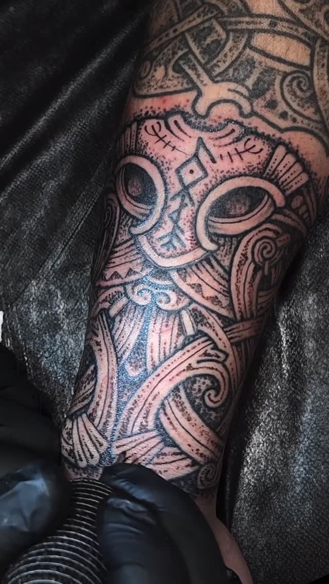 Bold blackwork tiki mask with geometric scrollwork