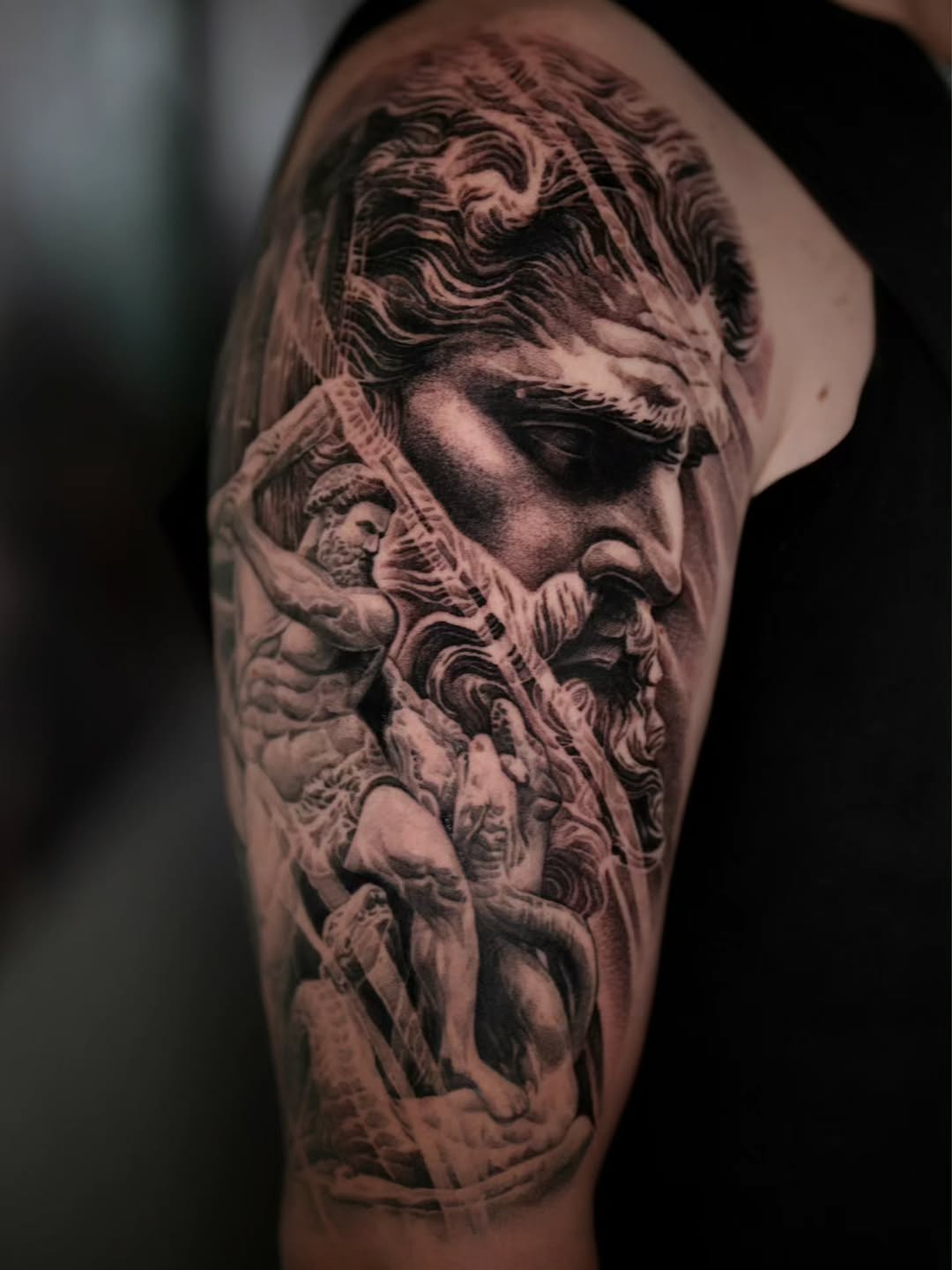 Monumental black-and-gray mythic bust entwined with hydra serpents