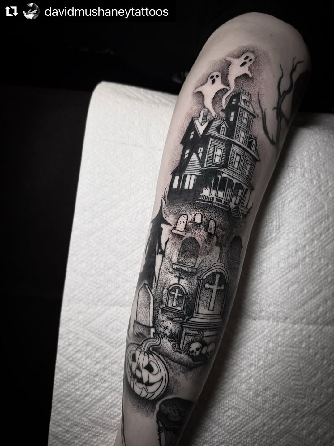 Haunted house with ghosts, tombstones, and pumpkin.