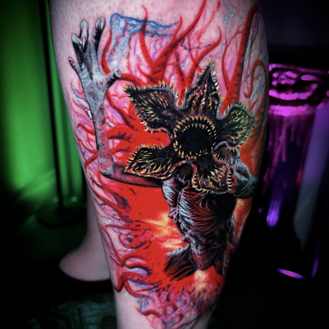 Vicious horror creature with petal-flower head, fiery crimson backdrop.