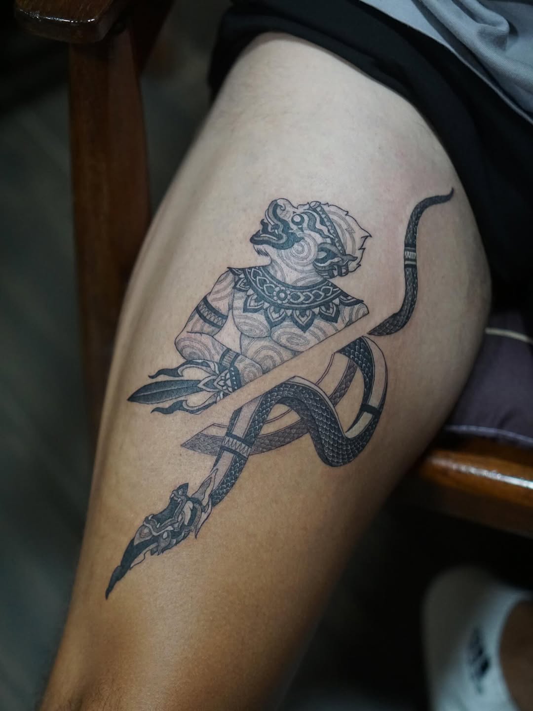 Ornate Hanuman with serpent Naga, bold blackwork