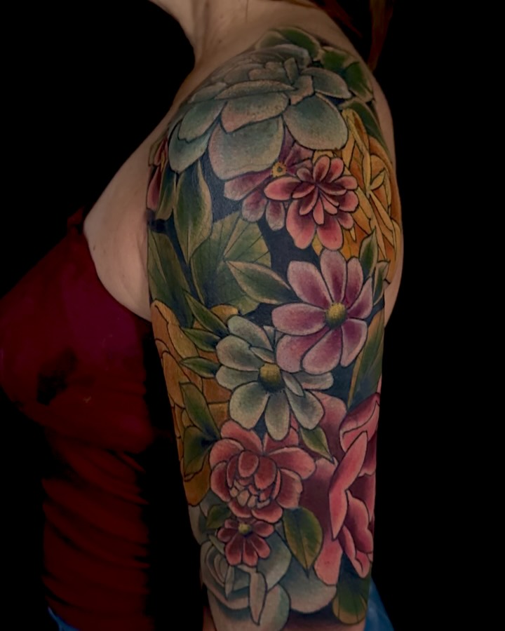 Vibrant floral sleeve with lush petals and greens