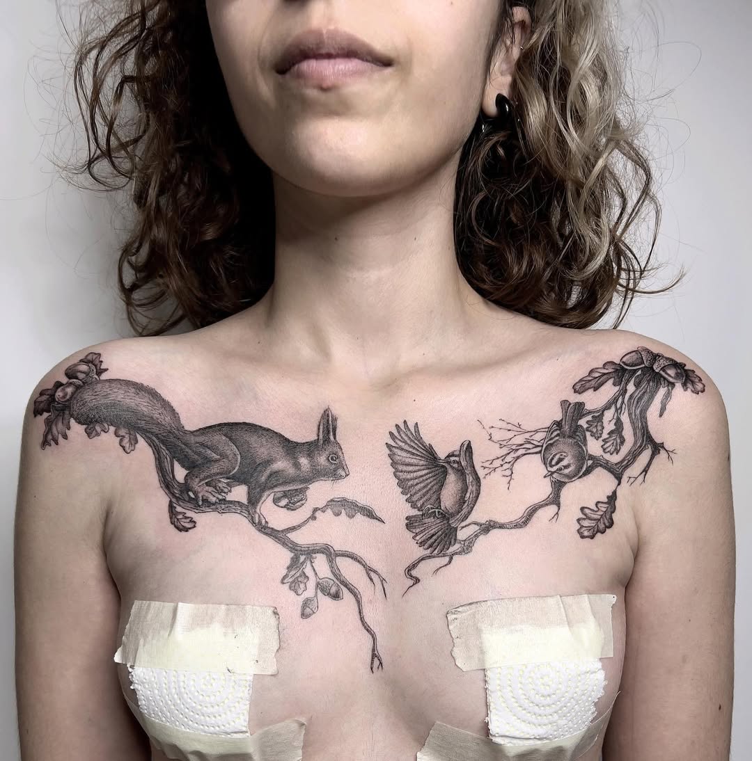 Striking black-and-gray chest piece with intertwined fauna