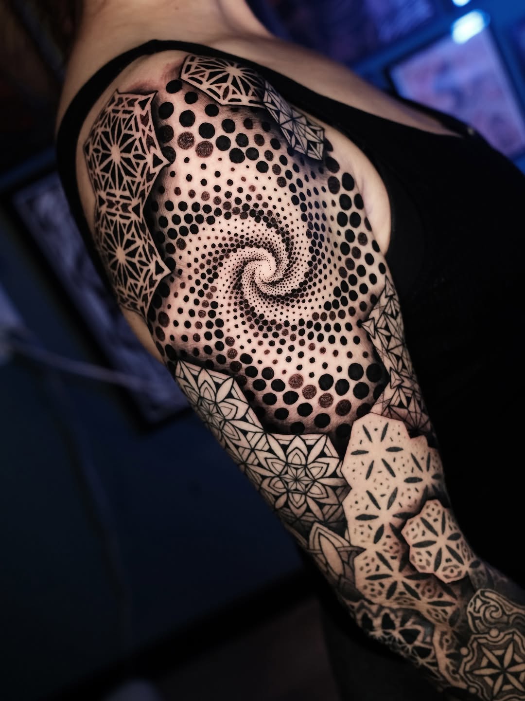 Intricate blackwork spiral dotwork with mandala-ornamented sleeve