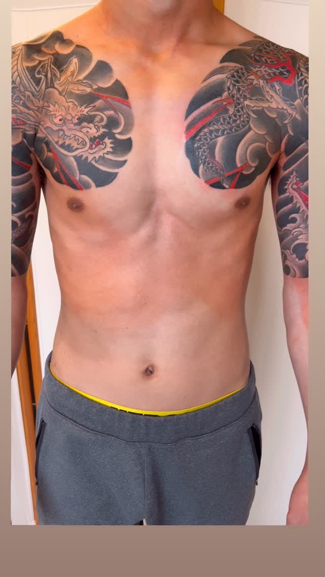 Monumental black-and-gray Japanese dragon sleeves with bold shading.