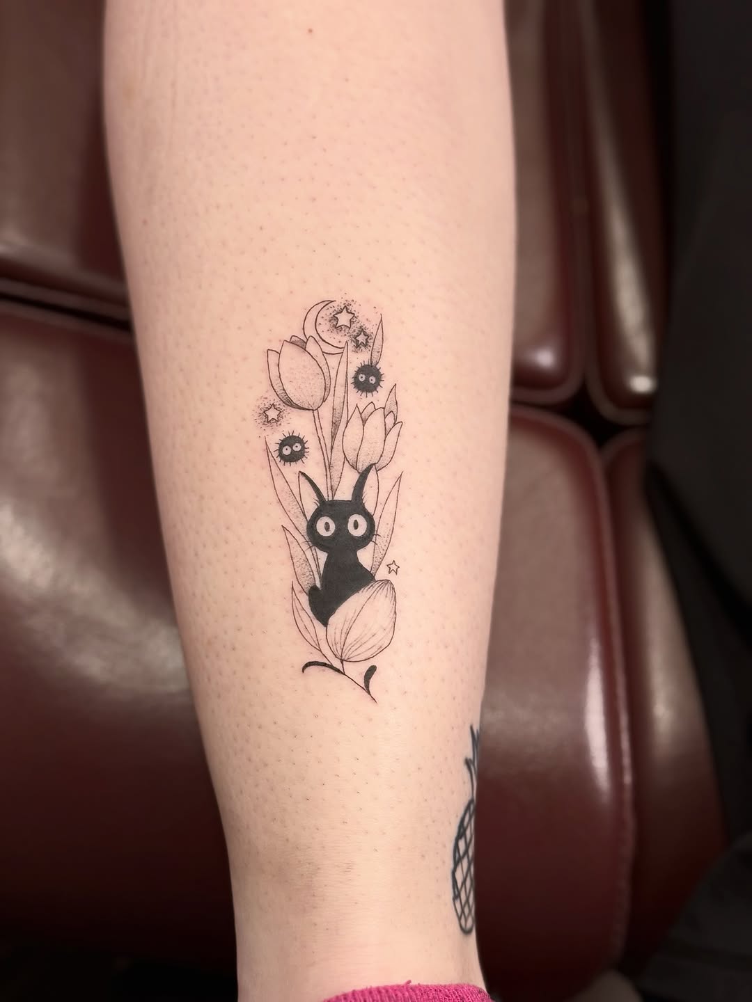 Whimsical black bunny among tulips with stars