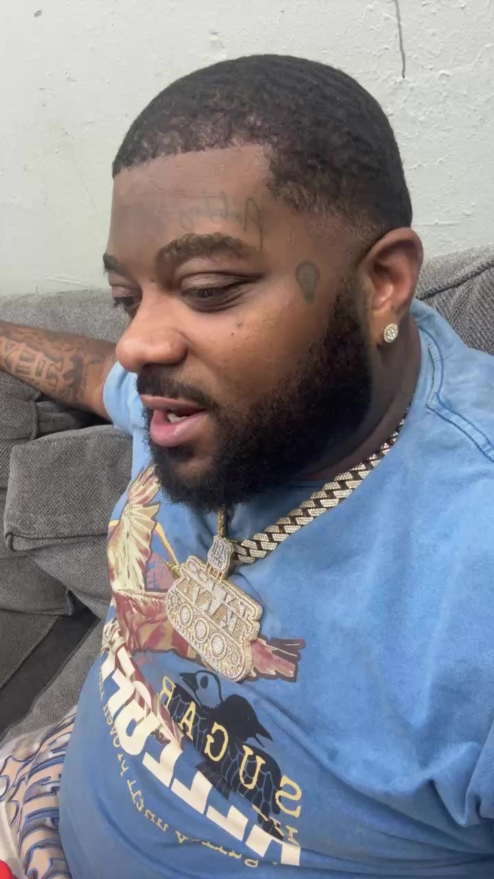 Small teardrop facial tattoo beneath the eye.