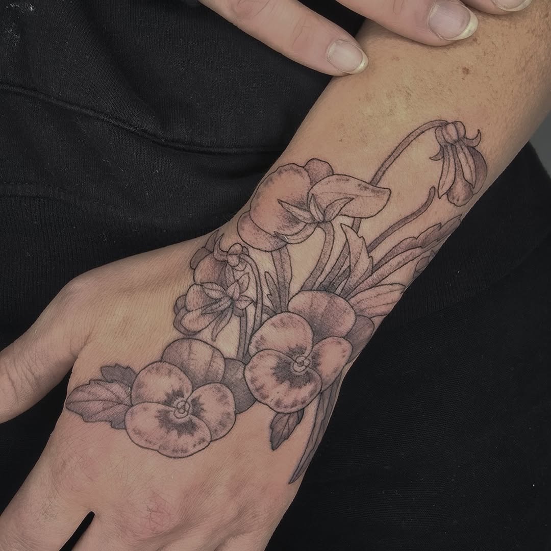 Delicate pansy floral wrist wrap in fine-line shading