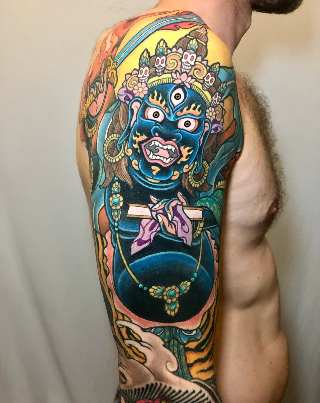 Vibrant oni-demon mask with ornate headdress and jewelry