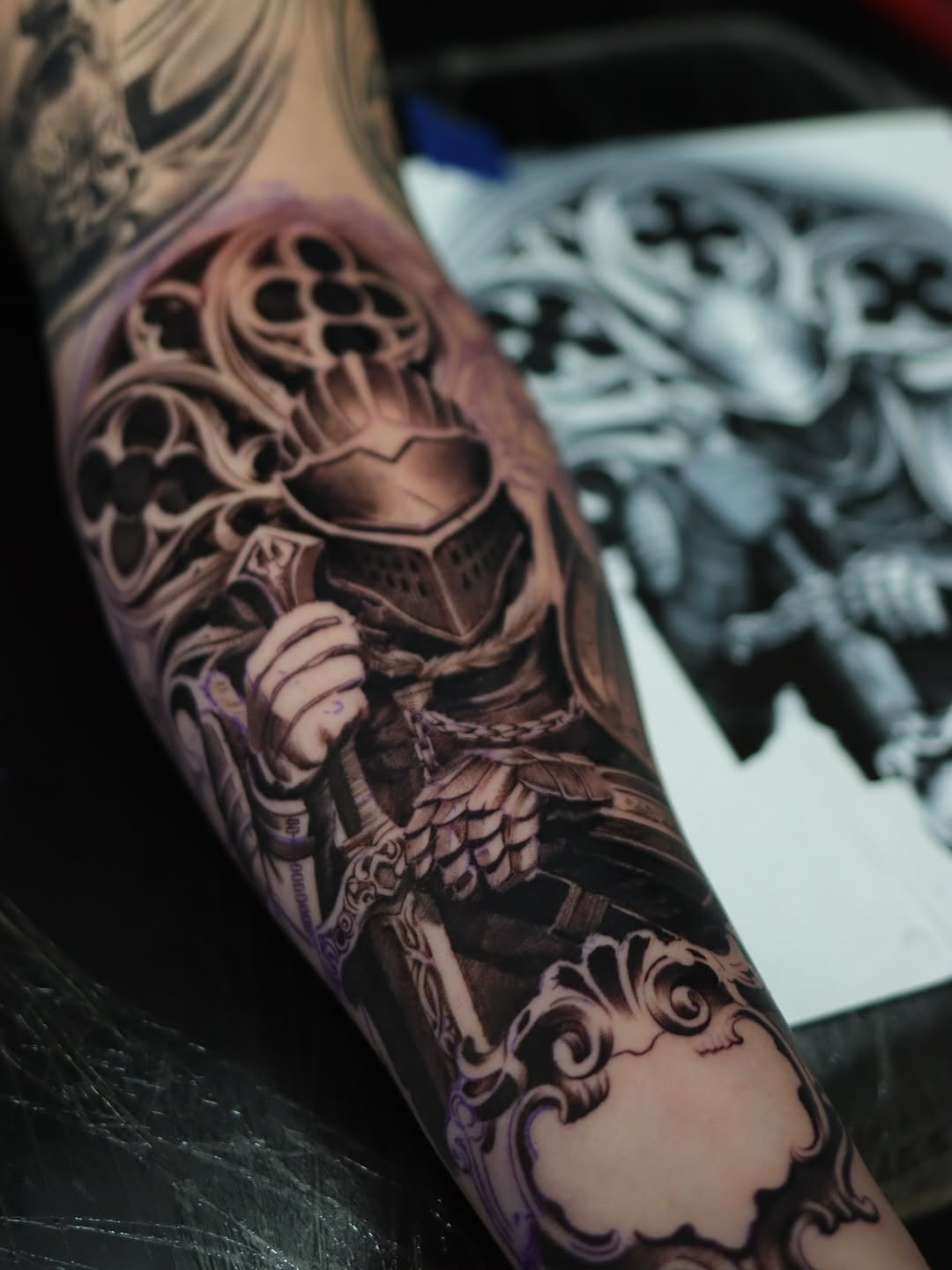 Bold black-and-gray knight-armor motif with ornate filigree