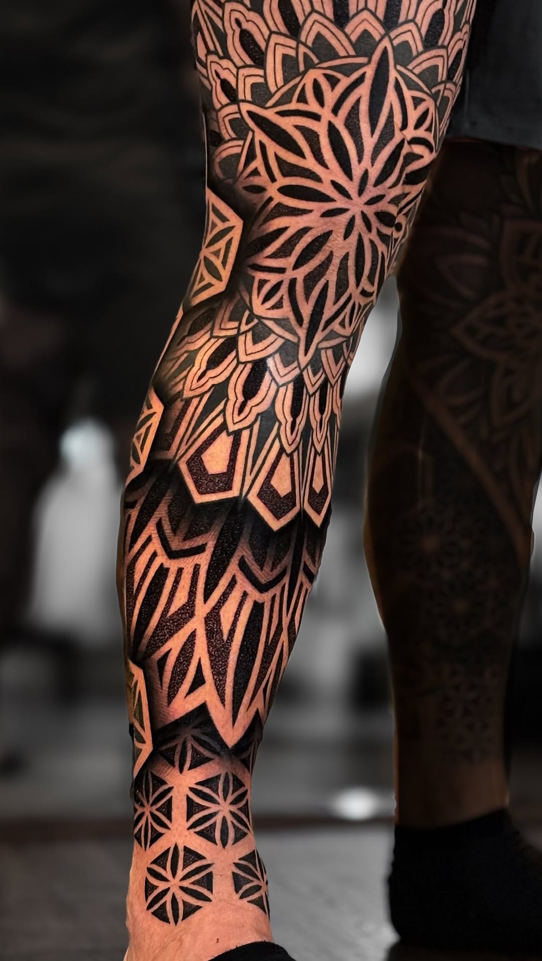 Crisp black geometric leg sleeve with mandala patterns.