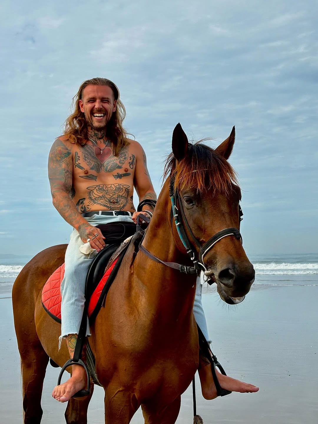 Tattooed rider on a horse, bold neo-traditional ink.