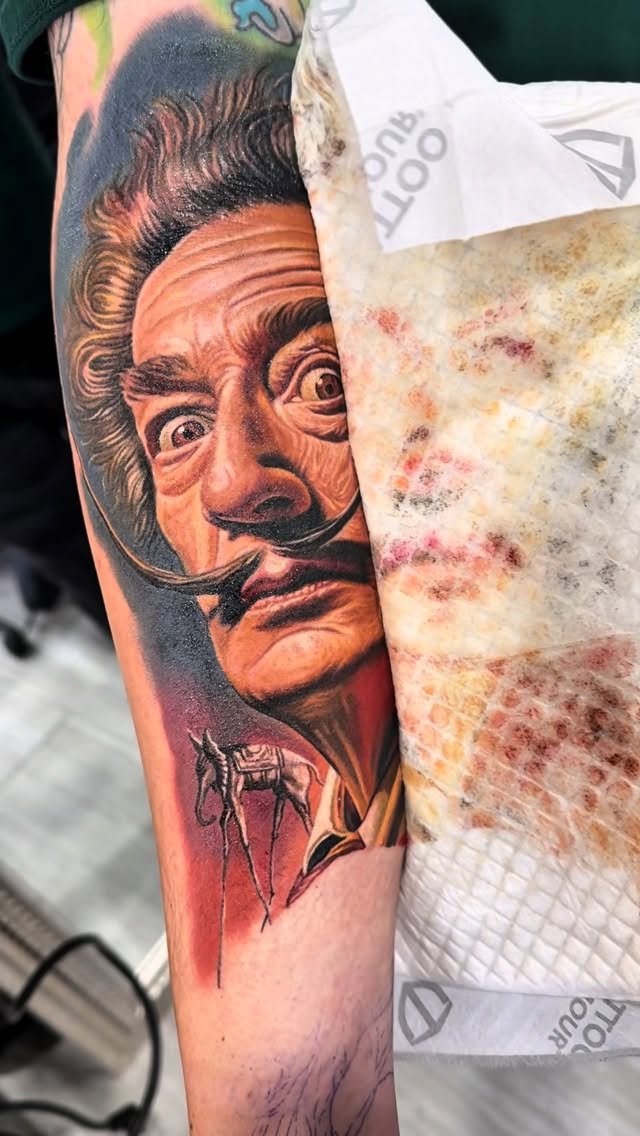 Hyper-detailed Dalí portrait tattoo with surreal flair