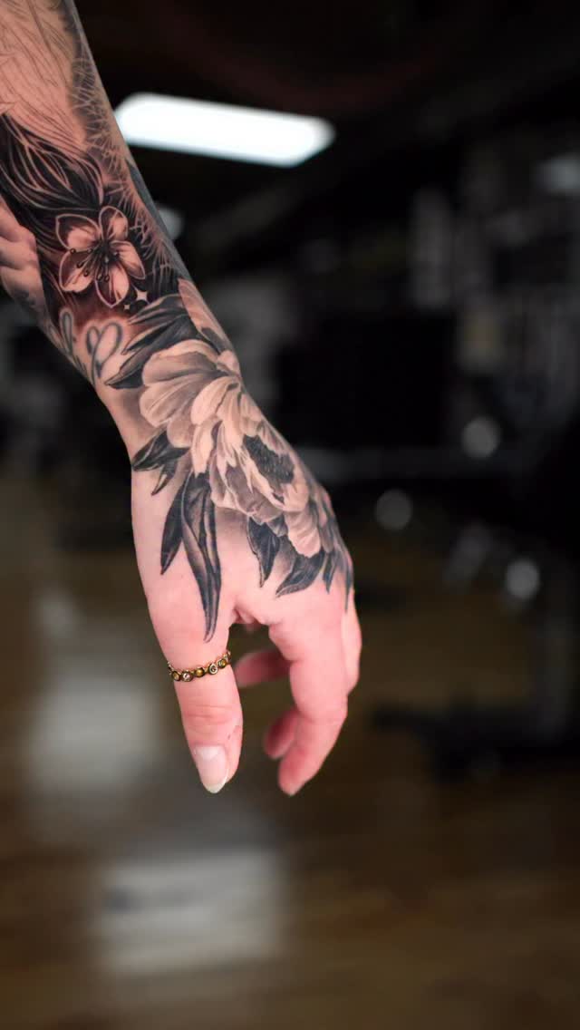 Graceful grayscale peony on the hand with lush shading
