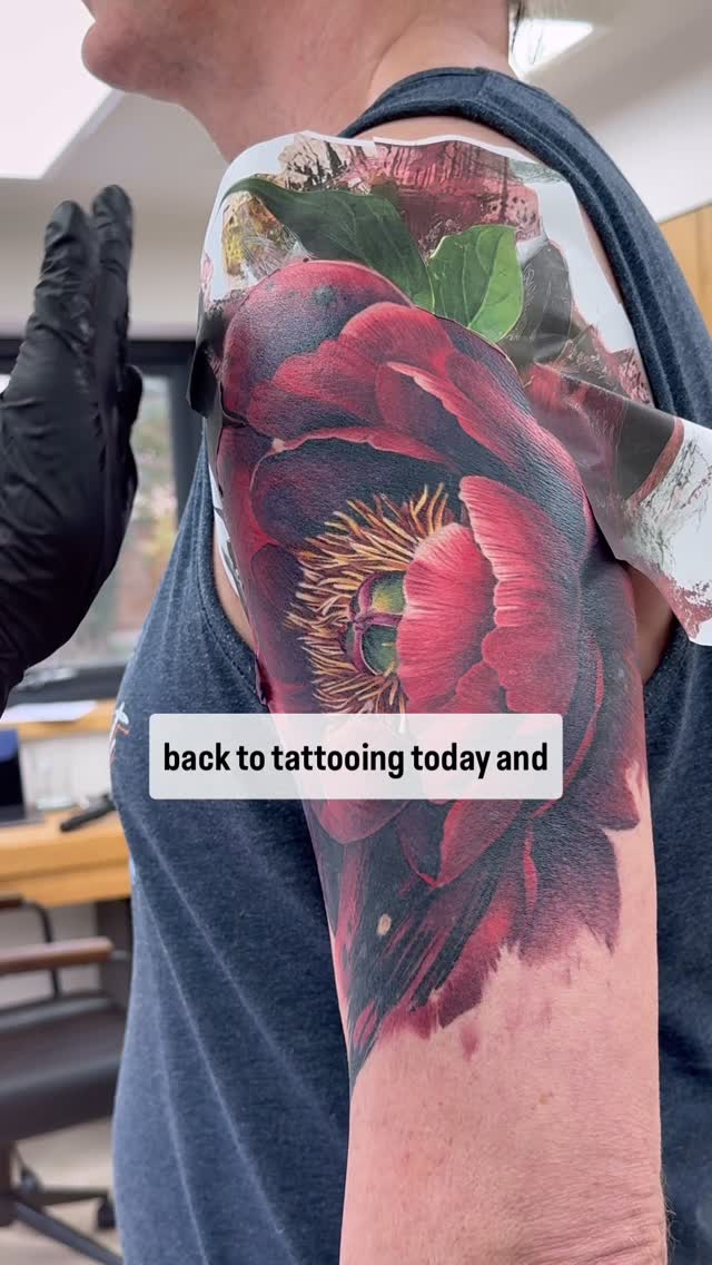 Vibrant color-realism peony blooms across the upper arm.