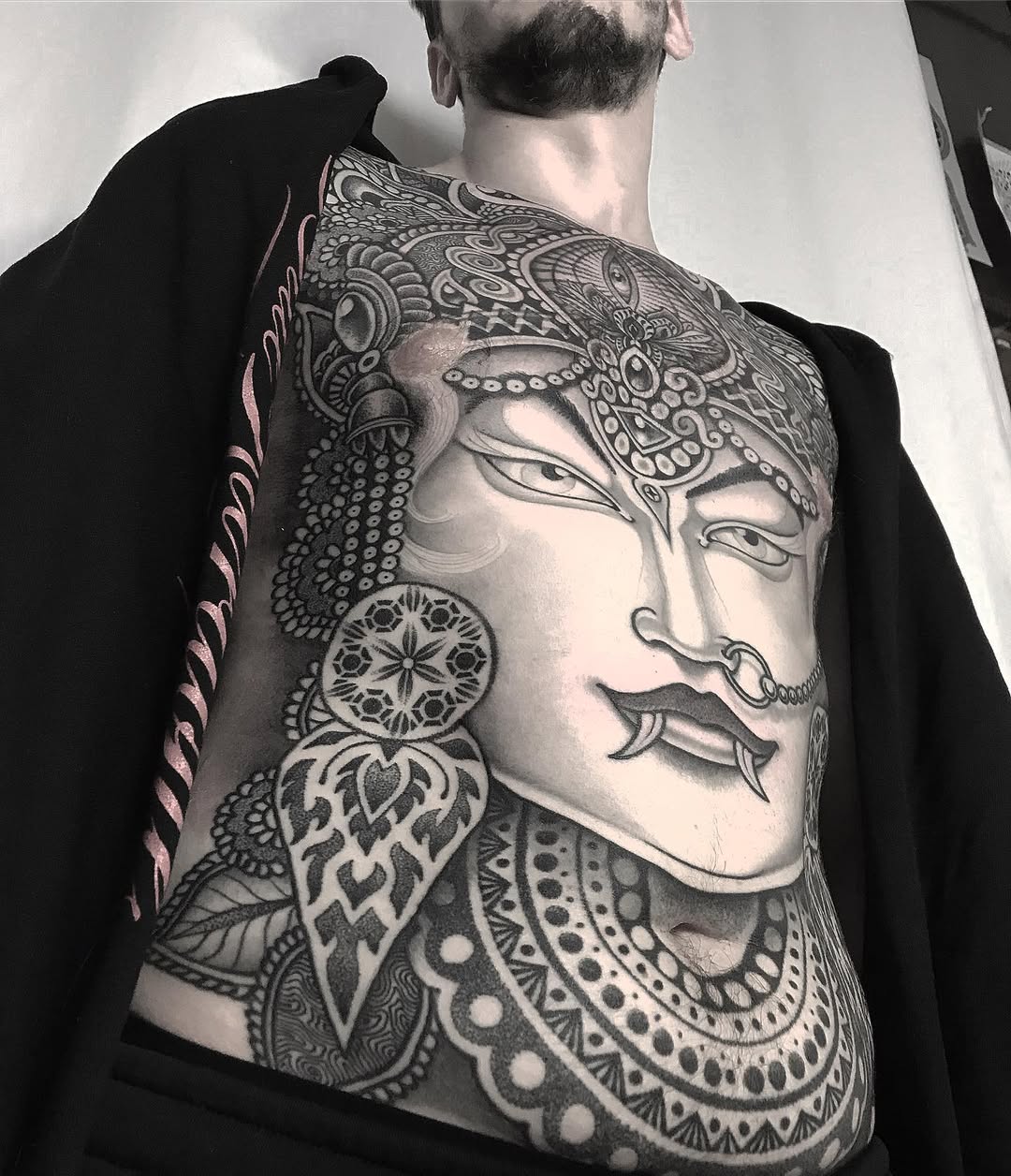 Intricate blackwork goddess portrait with ornate headdress