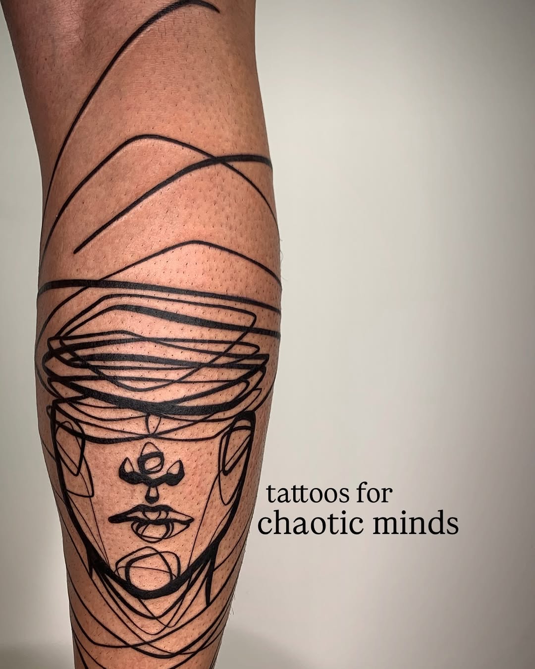 Bold abstract linework forming a chaotic, continuous-face portrait.