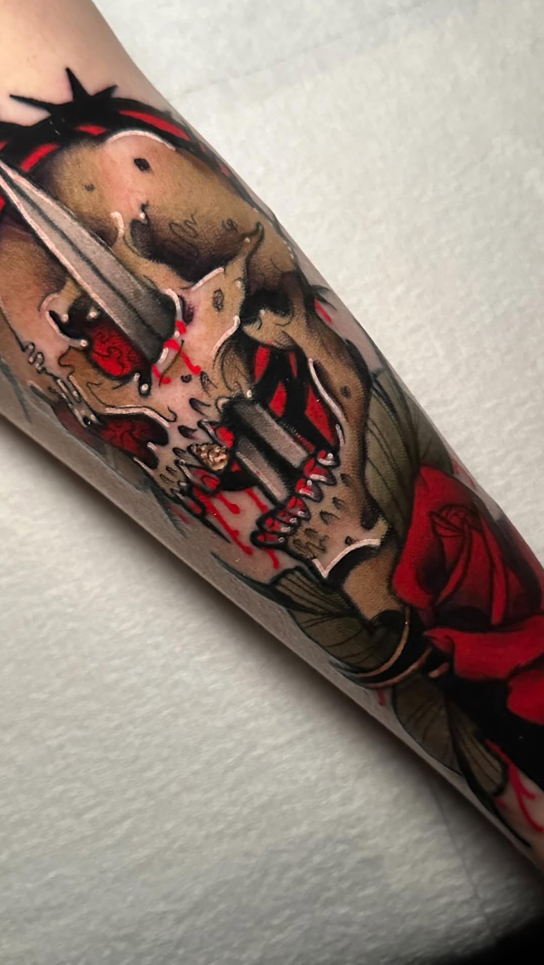 Bold neo-traditional skull and dagger with red rose