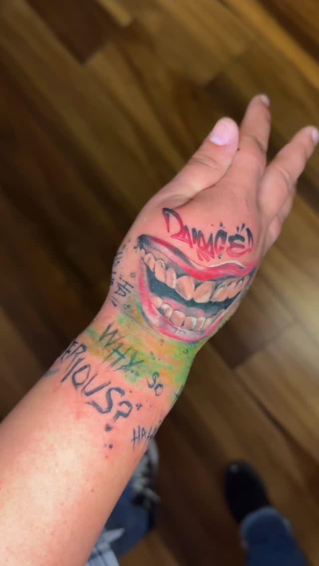 Vivid cover-up mouth with rainbow gradient on forearm