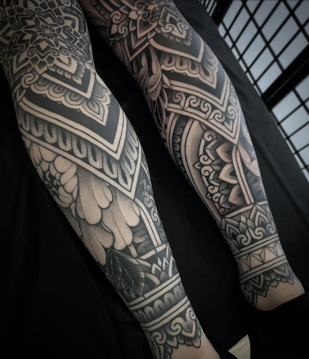Intricate blackwork ornamental leg sleeves with geometric motifs