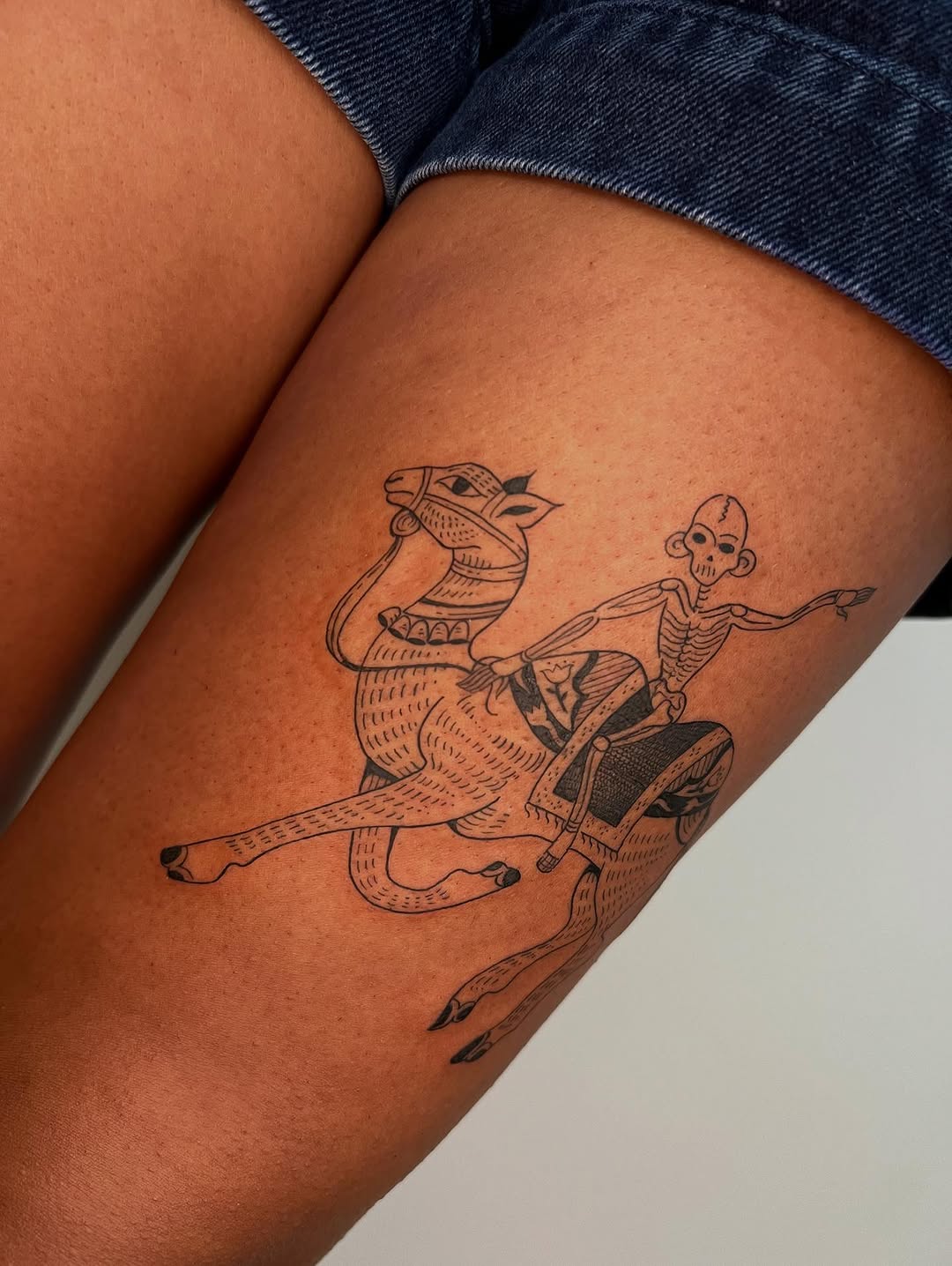 Whimsical skeleton rider on a camel, bold linework.