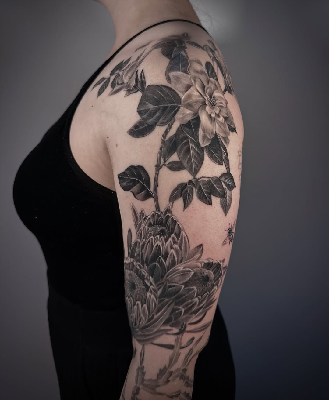 Lush black-and-gray botanical sleeve with bold florals.