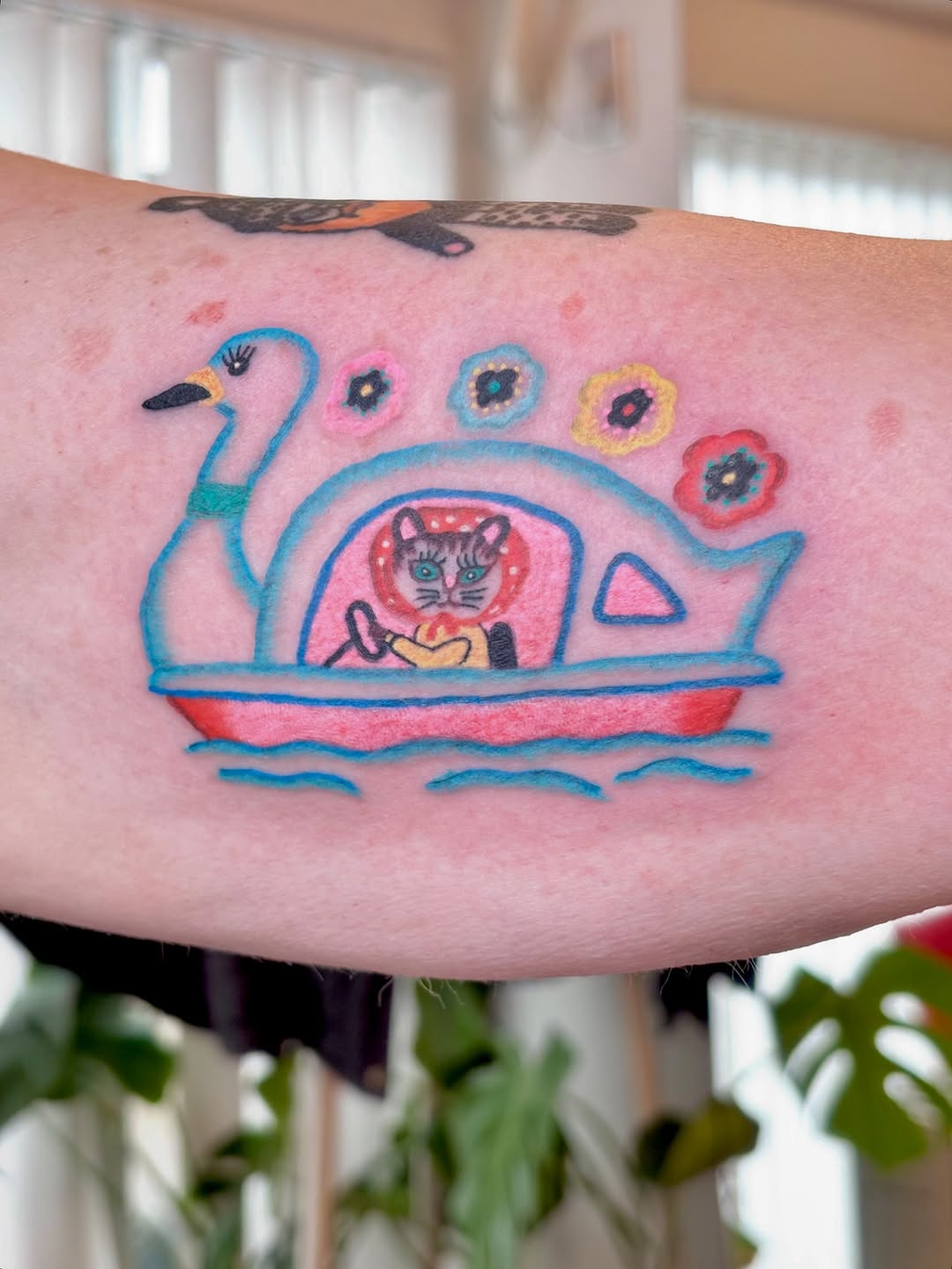 Whimsical cartoon swan-boat with a cat captain