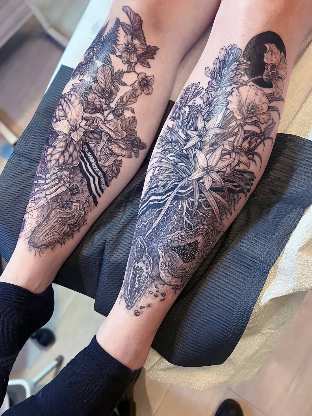 Intricate blackwork florals and oceanic textures across calves