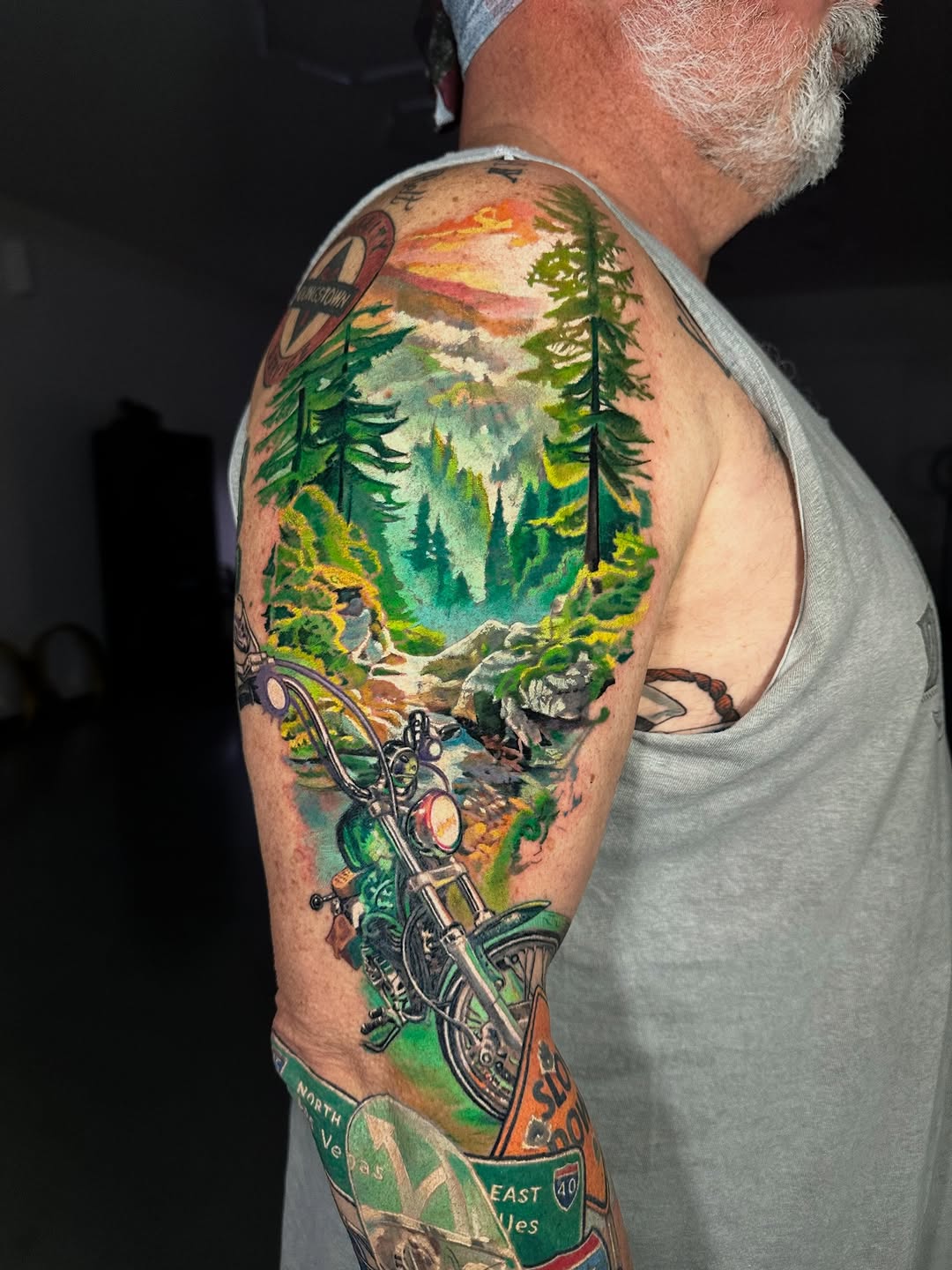 Vibrant mountain forest scene with a detailed motorcycle foreground