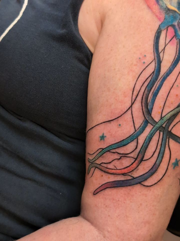 Vibrant watercolor jellyfish with flowing tentacles and stars