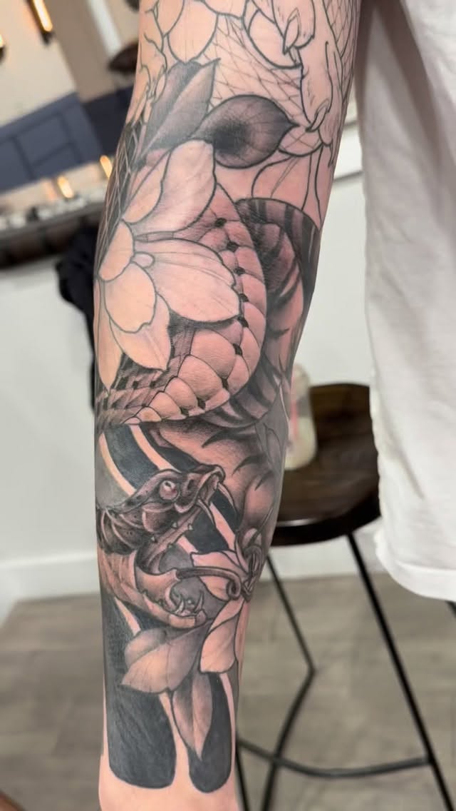 Detailed floral and snake sleeve