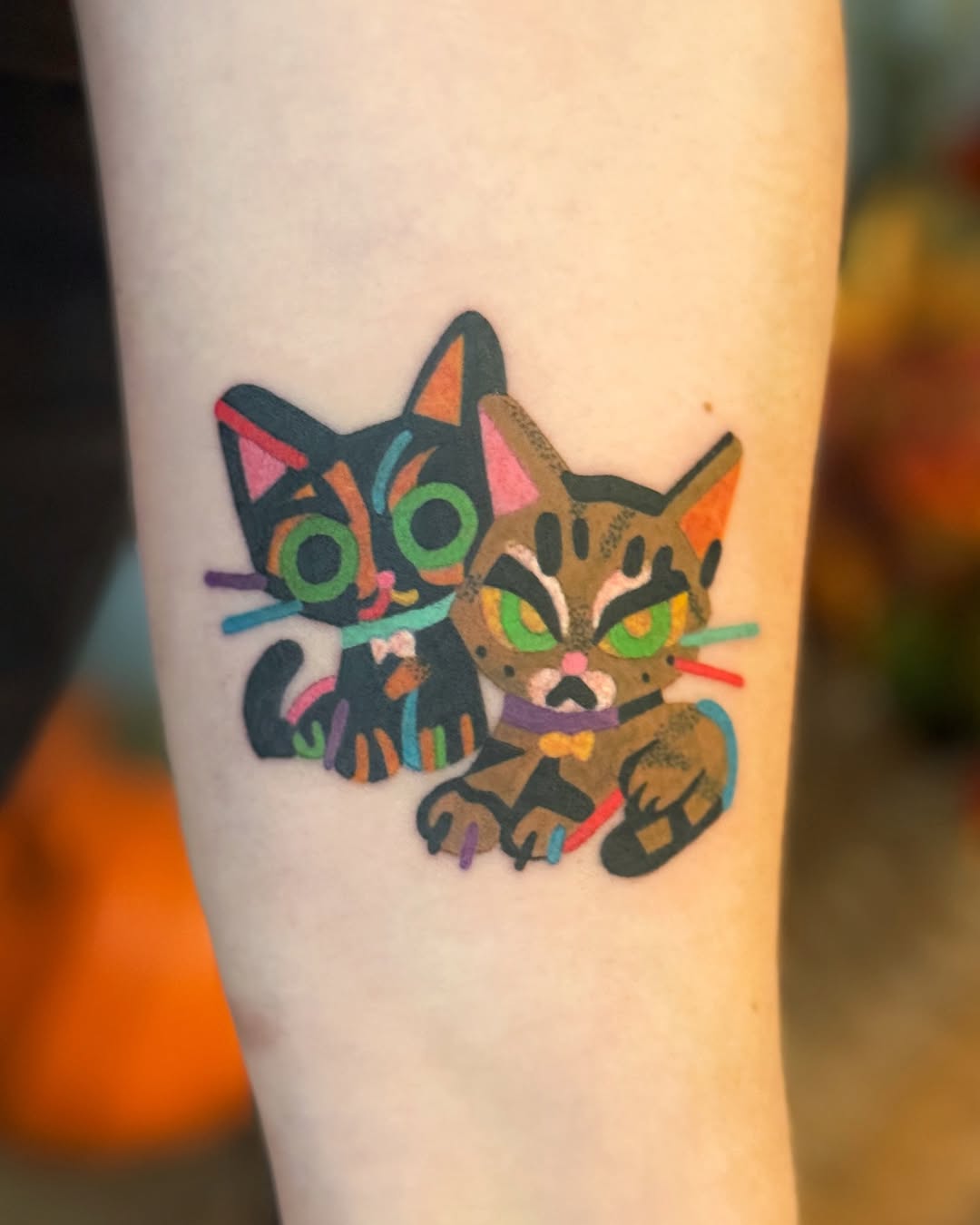 Bold, colorful cartoon cat duo with neon accents.