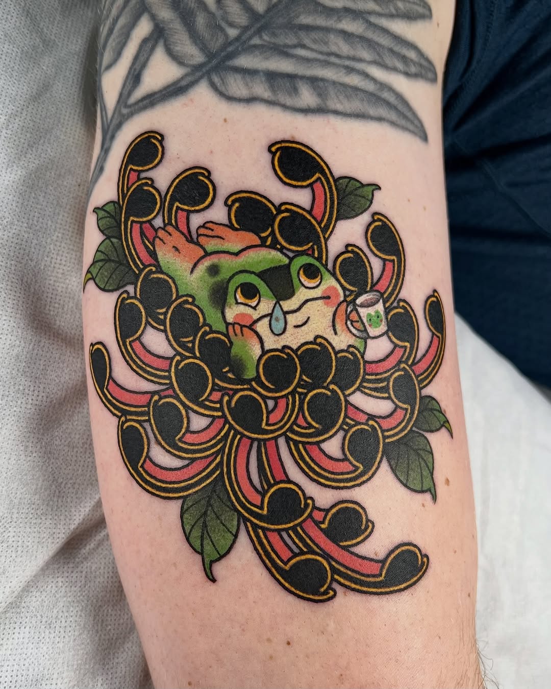 Bold traditional frog amid vibrant floral cluster.