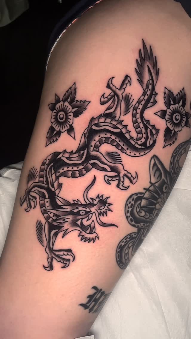 Bold traditional dragon with floral accents and bold lines