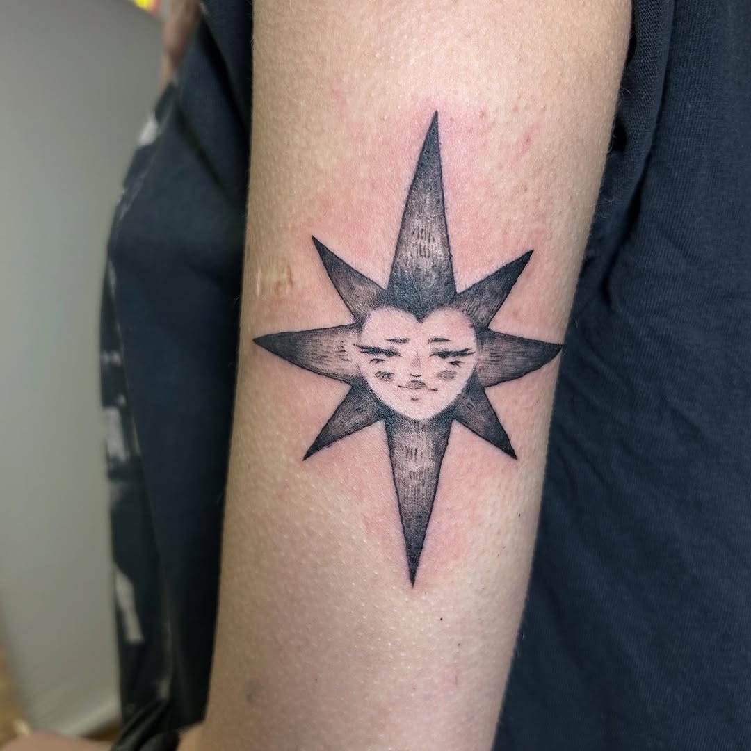 Monochrome eight-point sun with a serene, half-faced visage