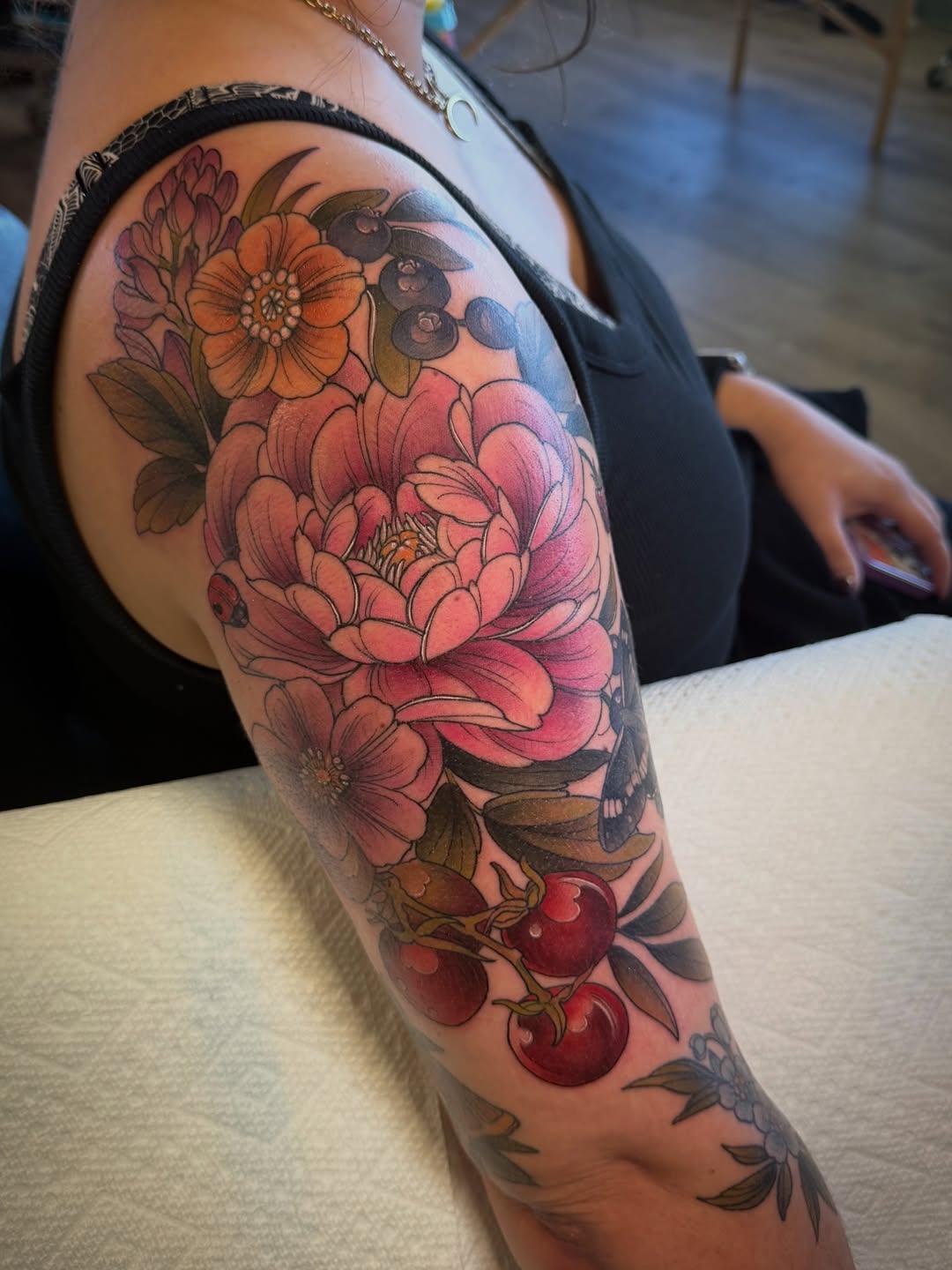 Vibrant garden bouquet of pink peonies and cherries.