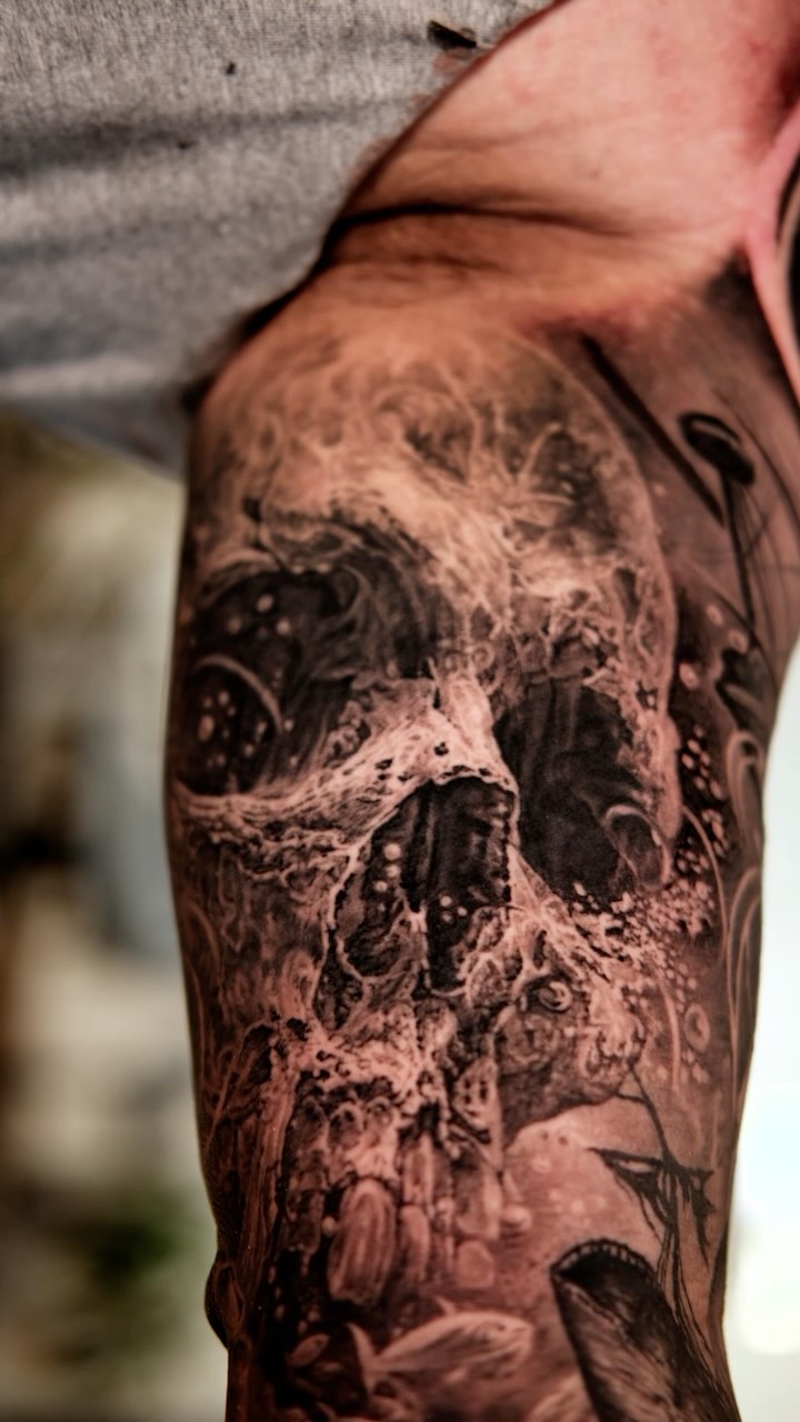 Dark surreal skull dissolves into chaotic black-gray ink