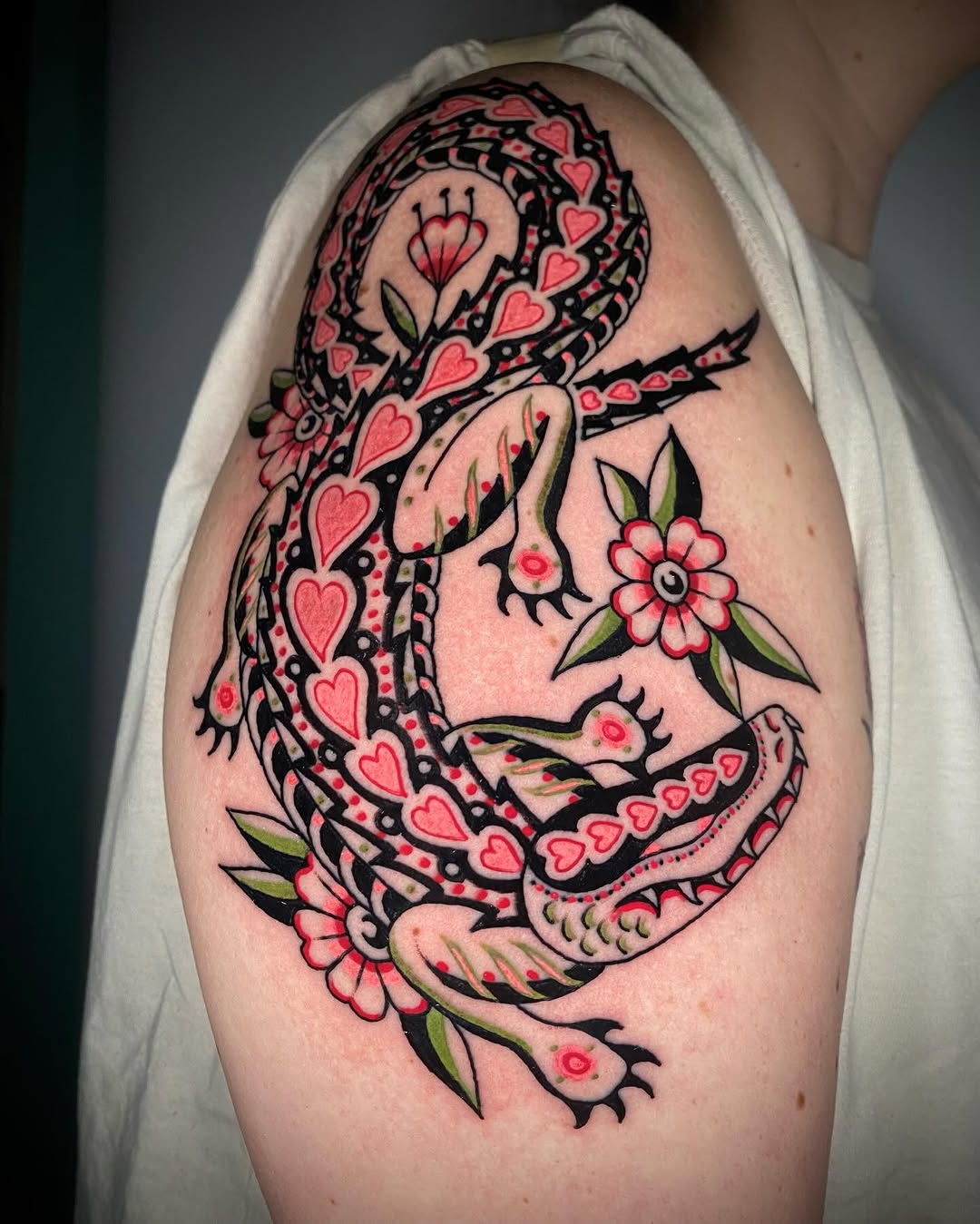 Bold black-outline serpent with heart-patterned scales and florals.