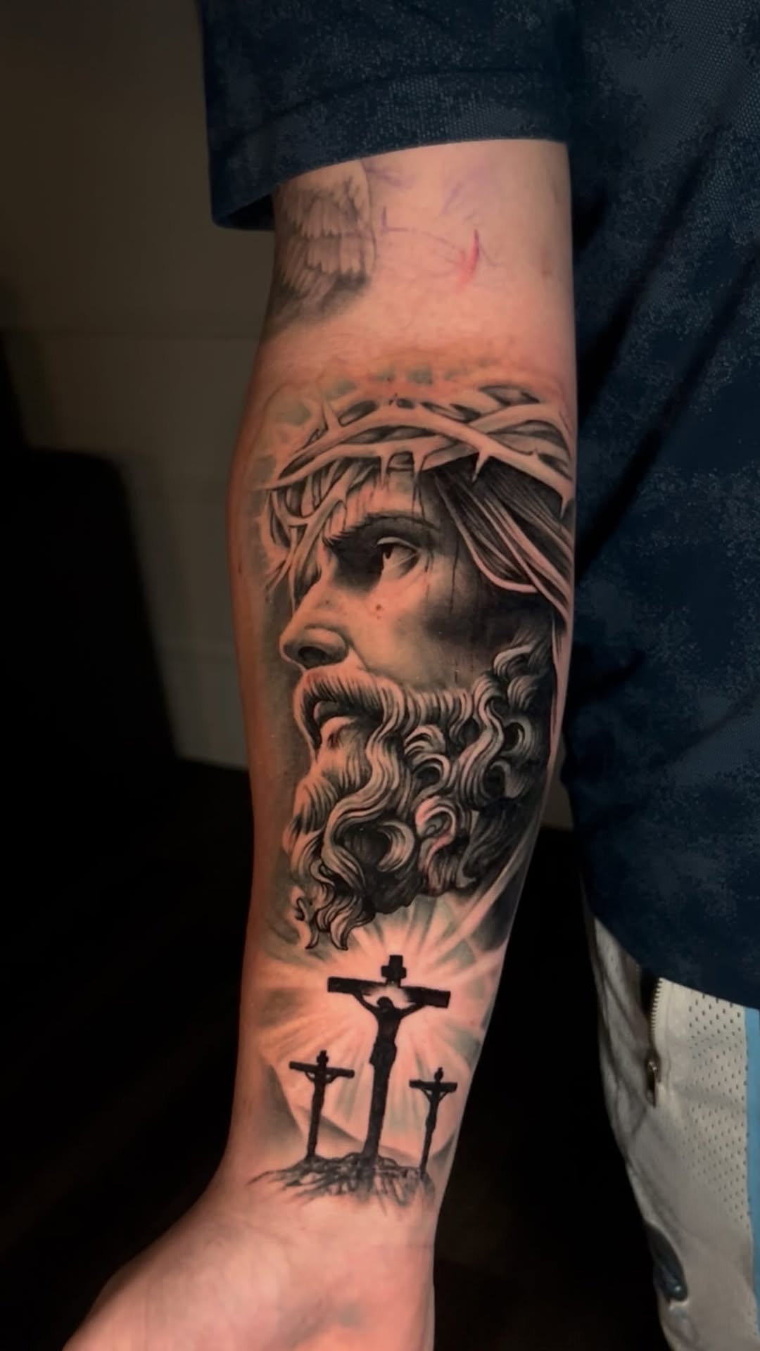 Photorealistic black-and-gray Jesus portrait with crown of thorns and crosses