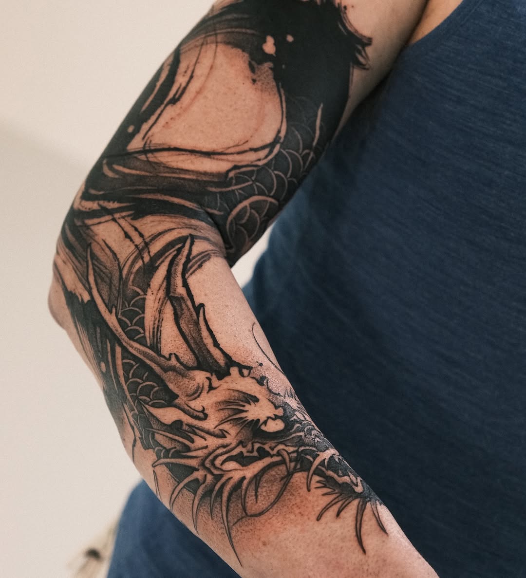 Bold Japanese dragon in blackwork with curling scales.