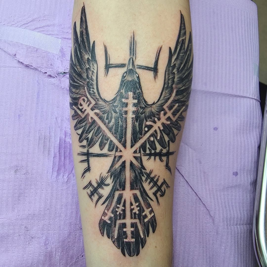 Bold black raven with vegvisir-inspired rune crosswork.