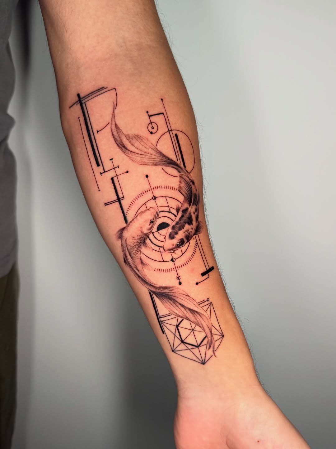 Geometric koi fish swim amid precise linework and circles.