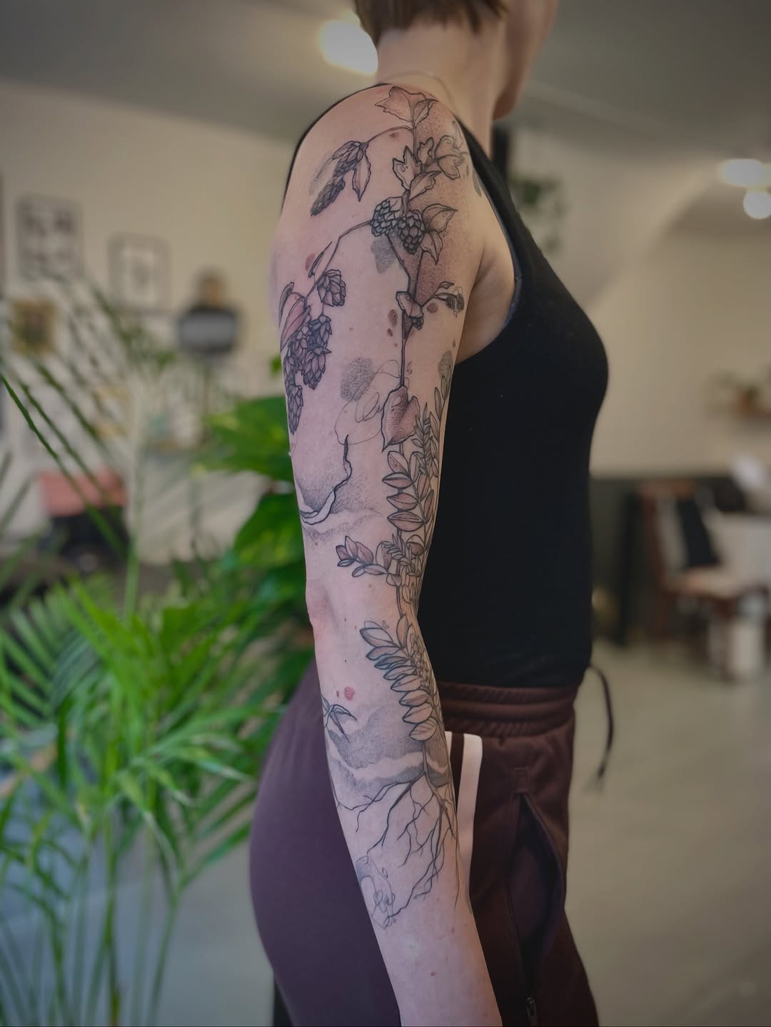 Delicate botanical vine sleeve in fine-line blackwork