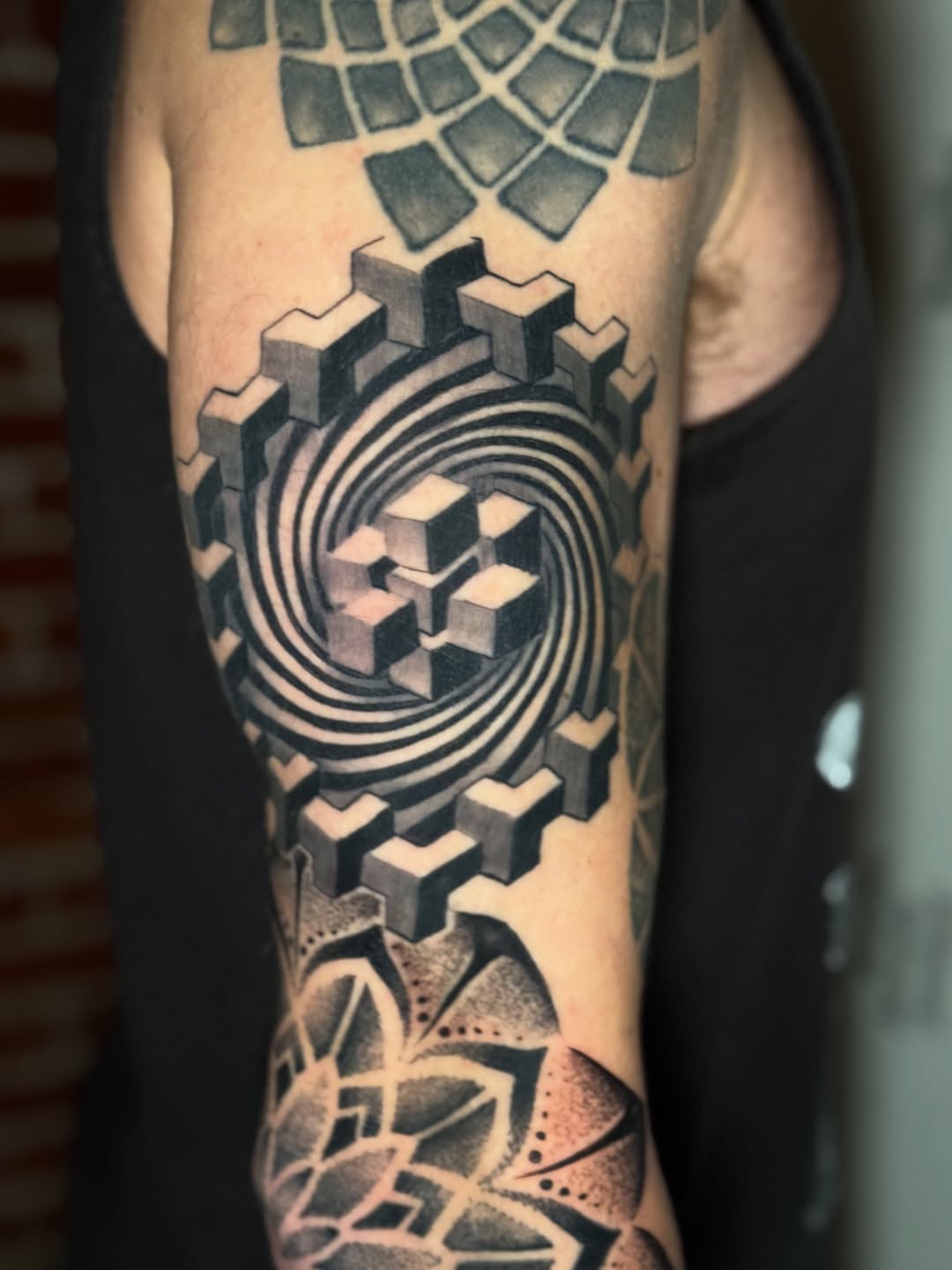 Hypnotic blackwork geometric sleeve with spiraling cube illusion