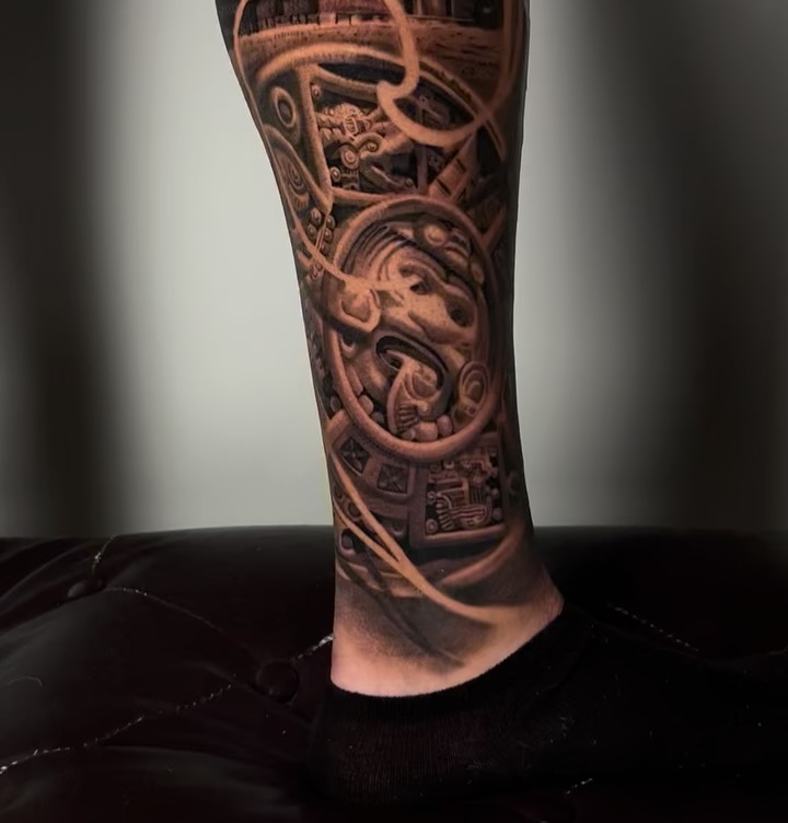 Intricate blackwork biomechanical leg sleeve with gears