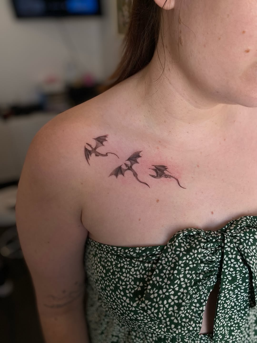 Three small flying bat silhouettes along the shoulder.