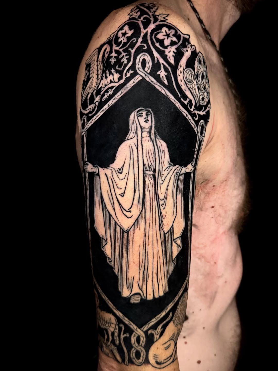 Dramatic hooded figure in a gothic-ornate frame