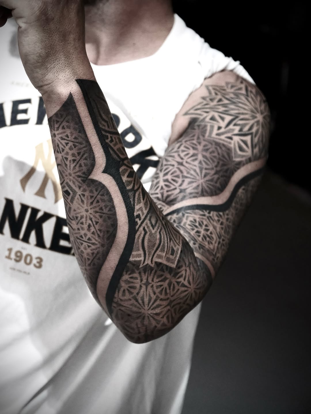 Intricate geometric sleeve with bold negative space bands.