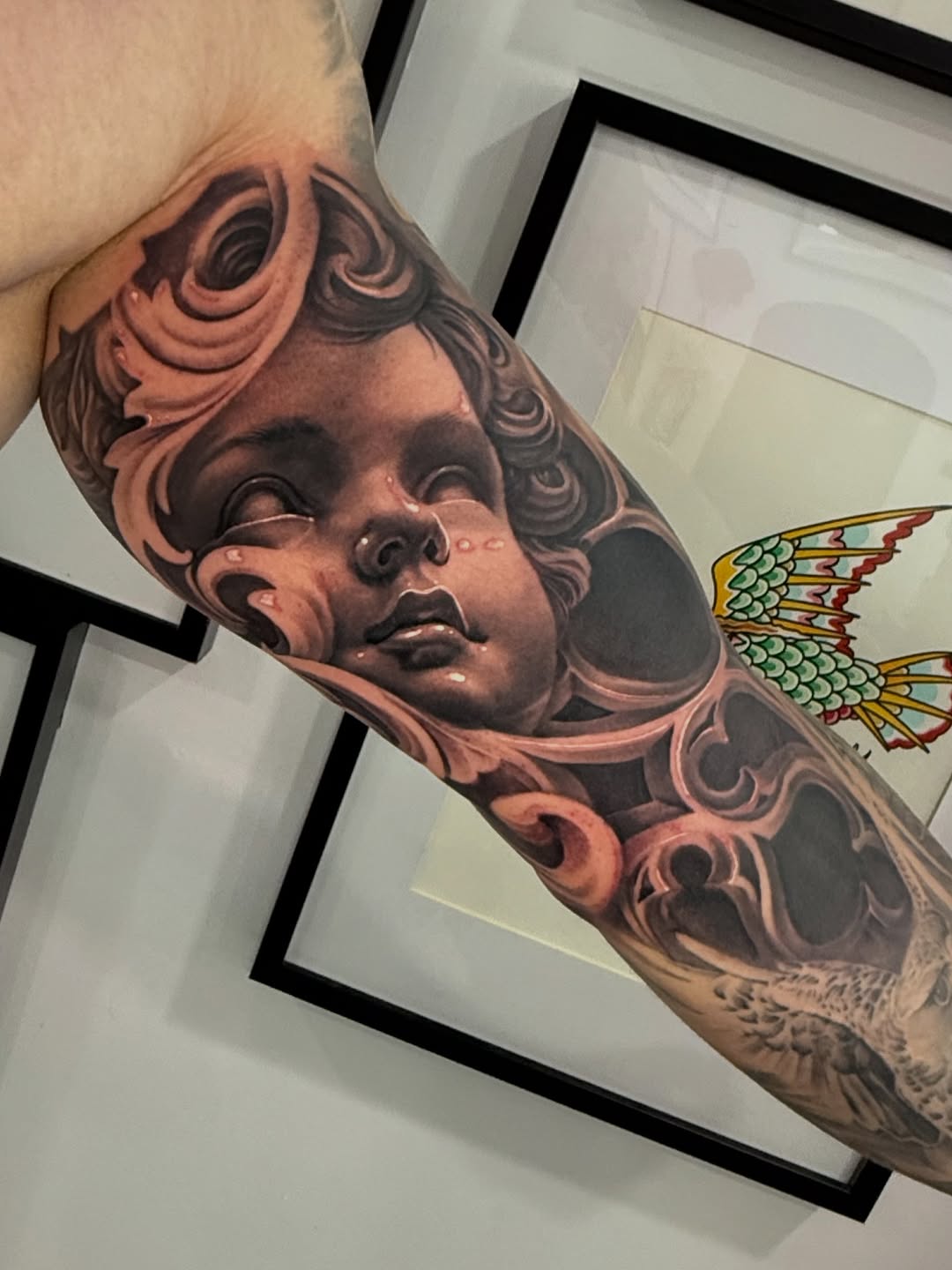 Serene cherub portrait with flowing ornamental scrollwork